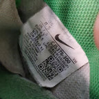 Close-up of a Nike label on a green fabric background