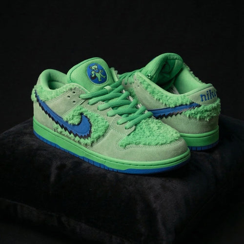 Green sneakers with blue accents on a black background